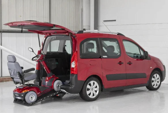 Véhicule rouge aménagé pour une personne handicapée en fauteuil roulant